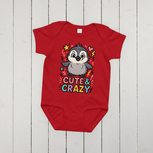 Red baby onesie with a penguin design and 'Cute & Crazy' text on a wooden surface