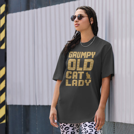 Woman wearing a dark gray t-shirt with 'Grumpy Old Cat Lady' text, standing against a striped wall.