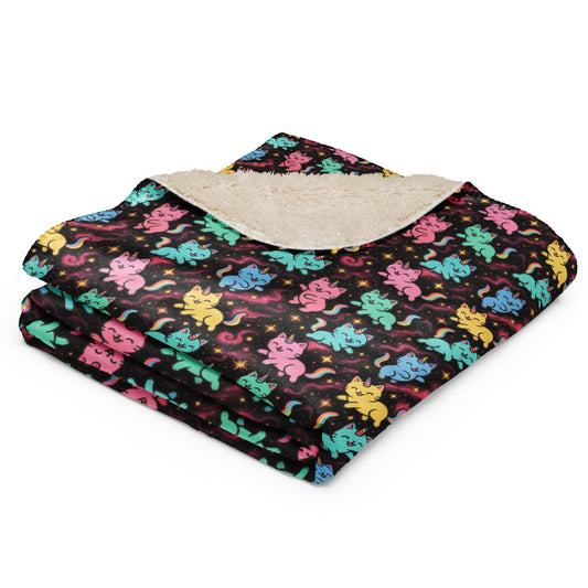 Folded blanket with colorful cat pattern on a white background