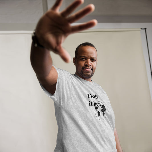 Man wearing a gray t-shirt with text and graphic, making a gesture with his hand.