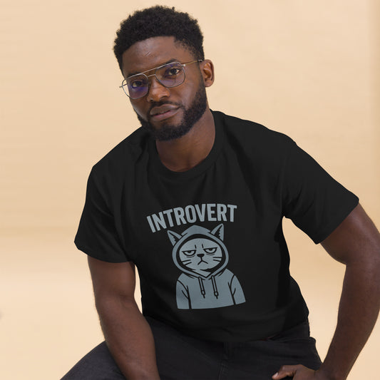 Man wearing a black t-shirt with 'Introvert' graphic design on a beige background