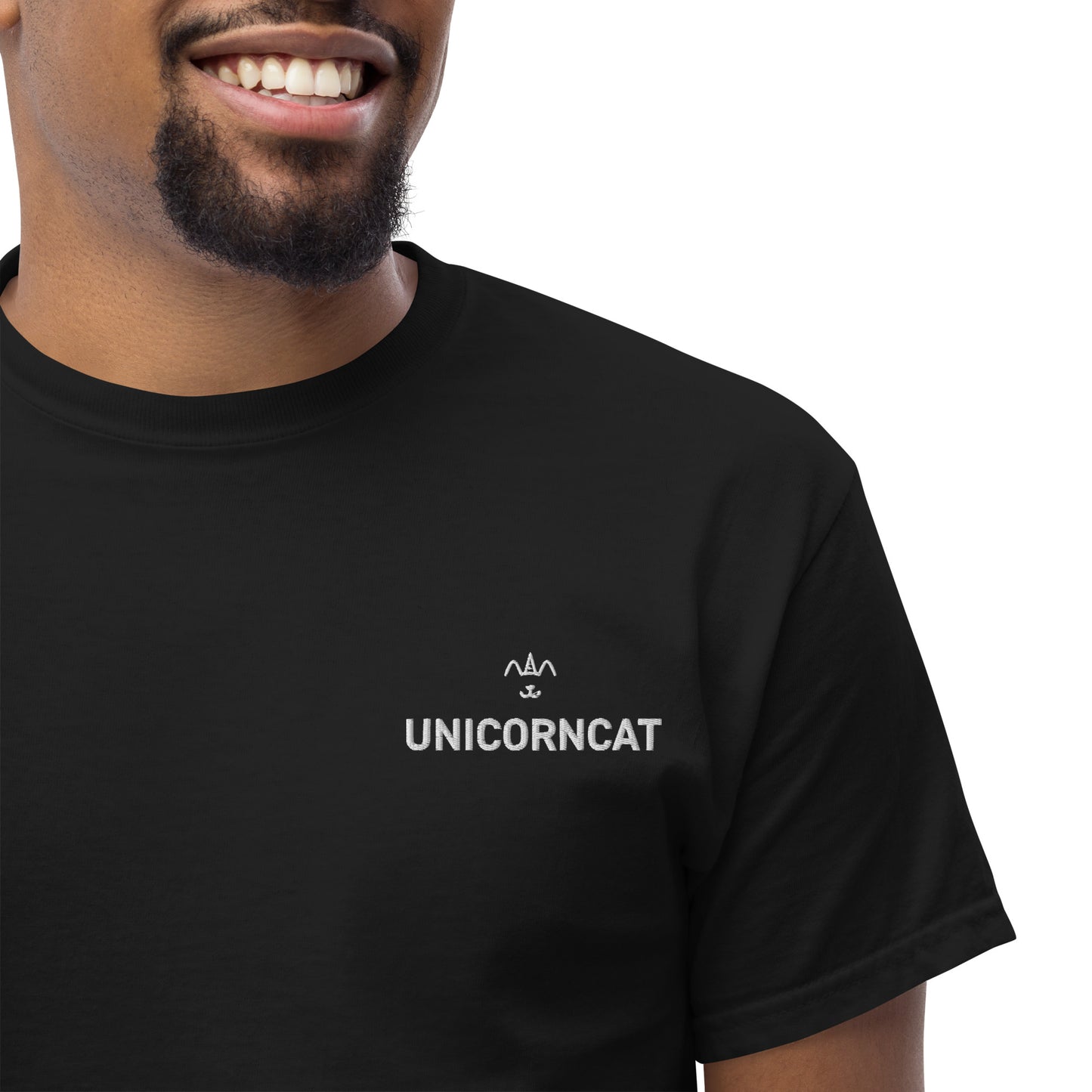 Person wearing a black t-shirt with 'UNICORNCAT' logo