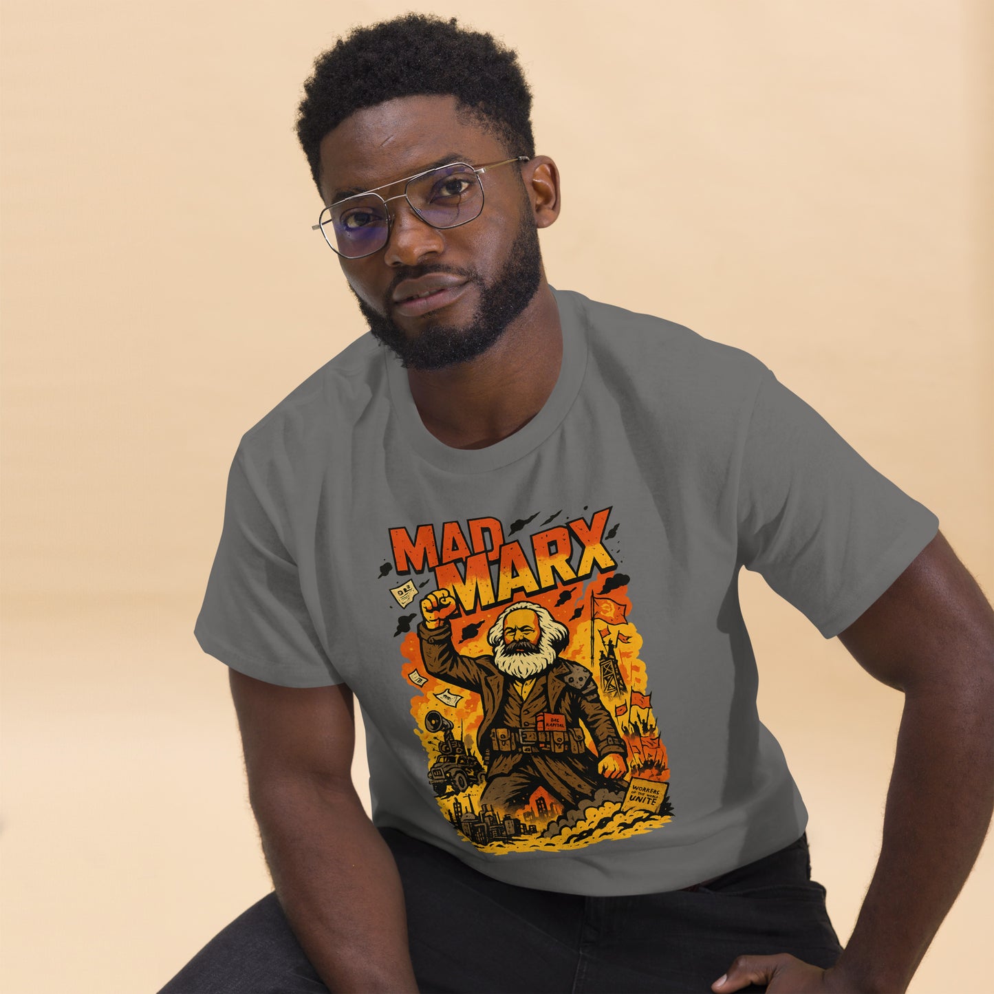 Man wearing a gray t-shirt with a graphic design of Karl Marx on a beige background