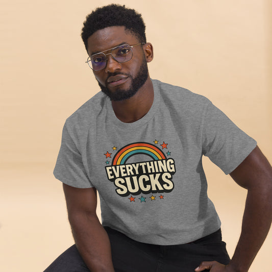 Man wearing a gray t-shirt with 'Everything Sucks' graphic on a beige background