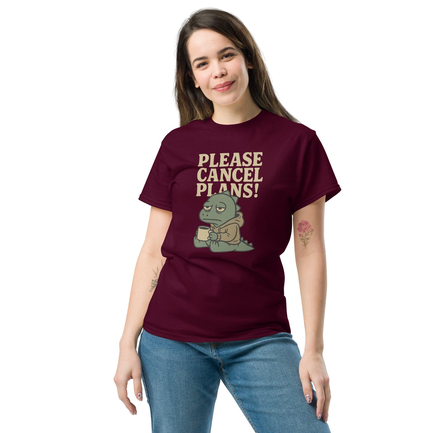 Woman wearing a maroon t-shirt with a graphic and text 'PLEASE CANCEL PLANS!' on a white background
