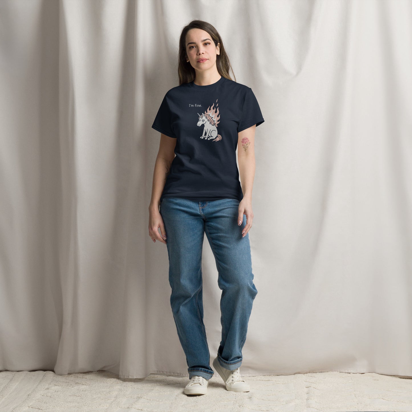 Person wearing a black t-shirt with a graphic design against a plain background