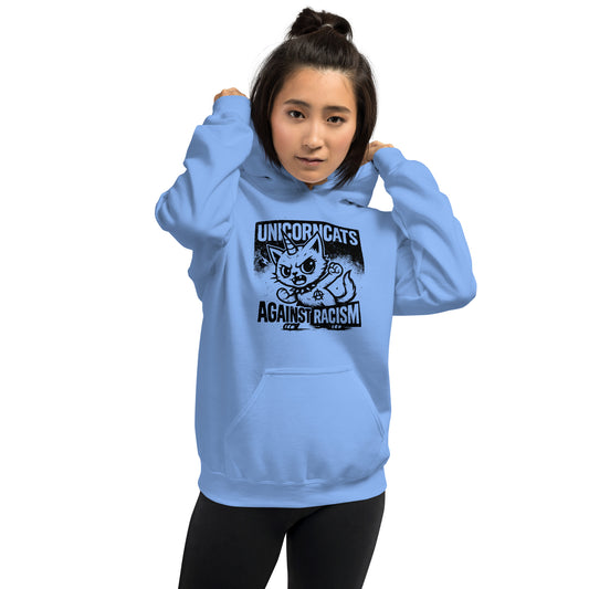 Woman wearing light blue hoodie with a unicorncat and a text reading "Unicorncats against racism"