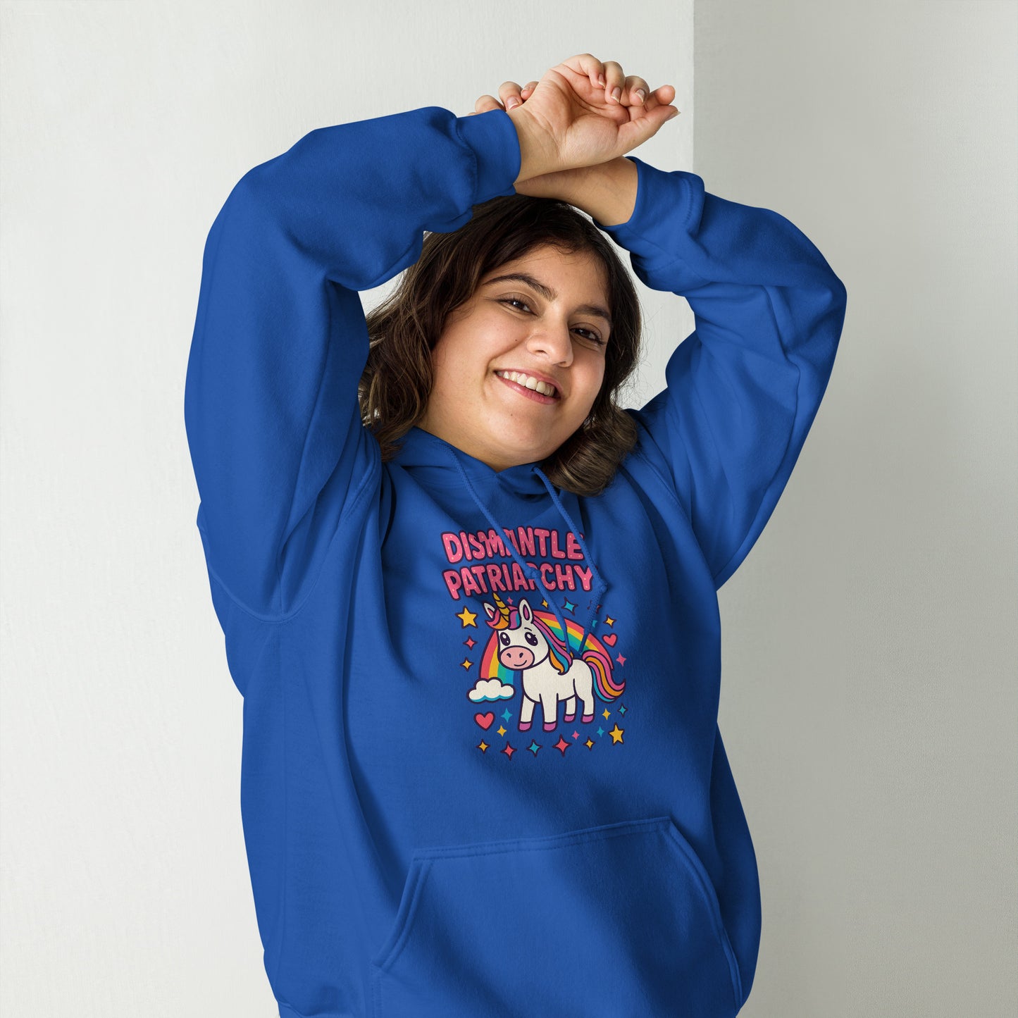 Person wearing a blue hoodie with a unicorn graphic and text, standing against a plain background