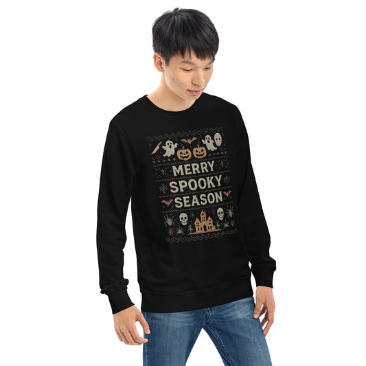 Person wearing a black Halloween-themed sweater with festive graphics on a white background