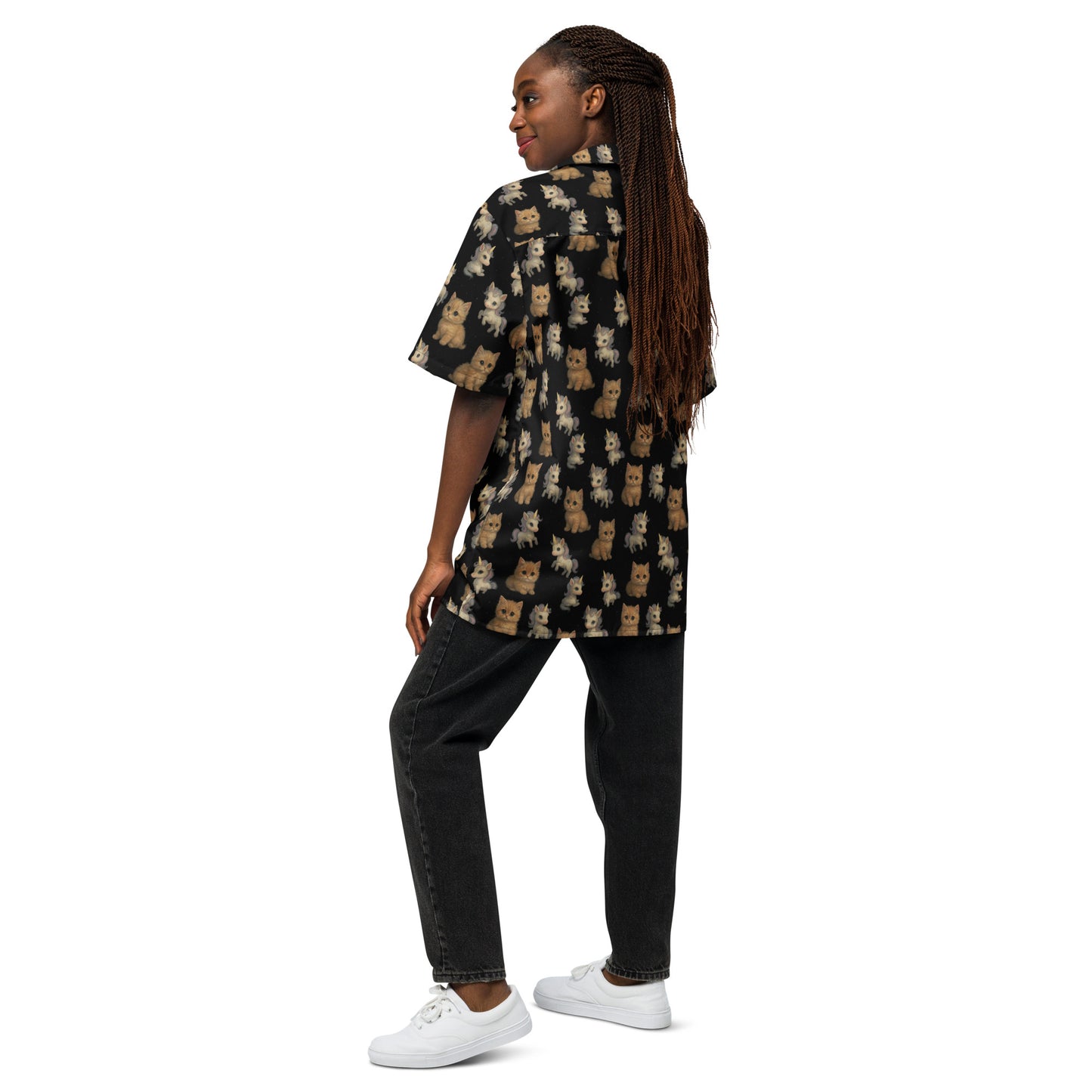 Person wearing a patterned shirt and black pants on a white background