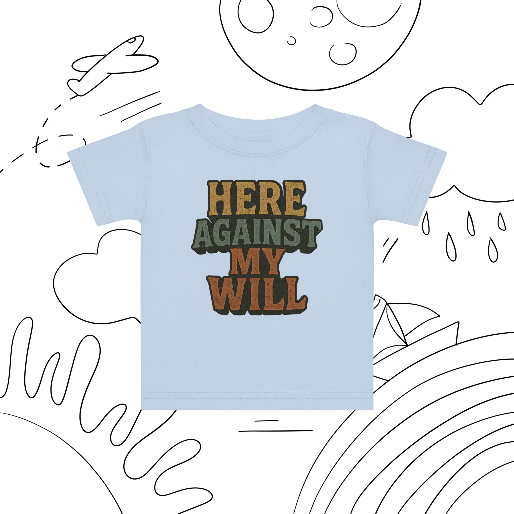 Light blue t-shirt with text 'HERE AGAINST MY WILL' on a white background with black line art.