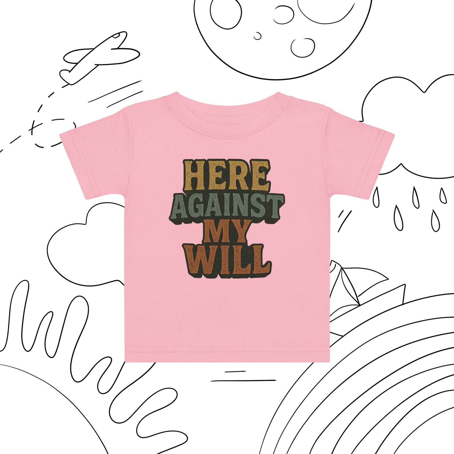 Pink t-shirt with 'HERE AGAINST MY WILL' text on a white background with black line art.