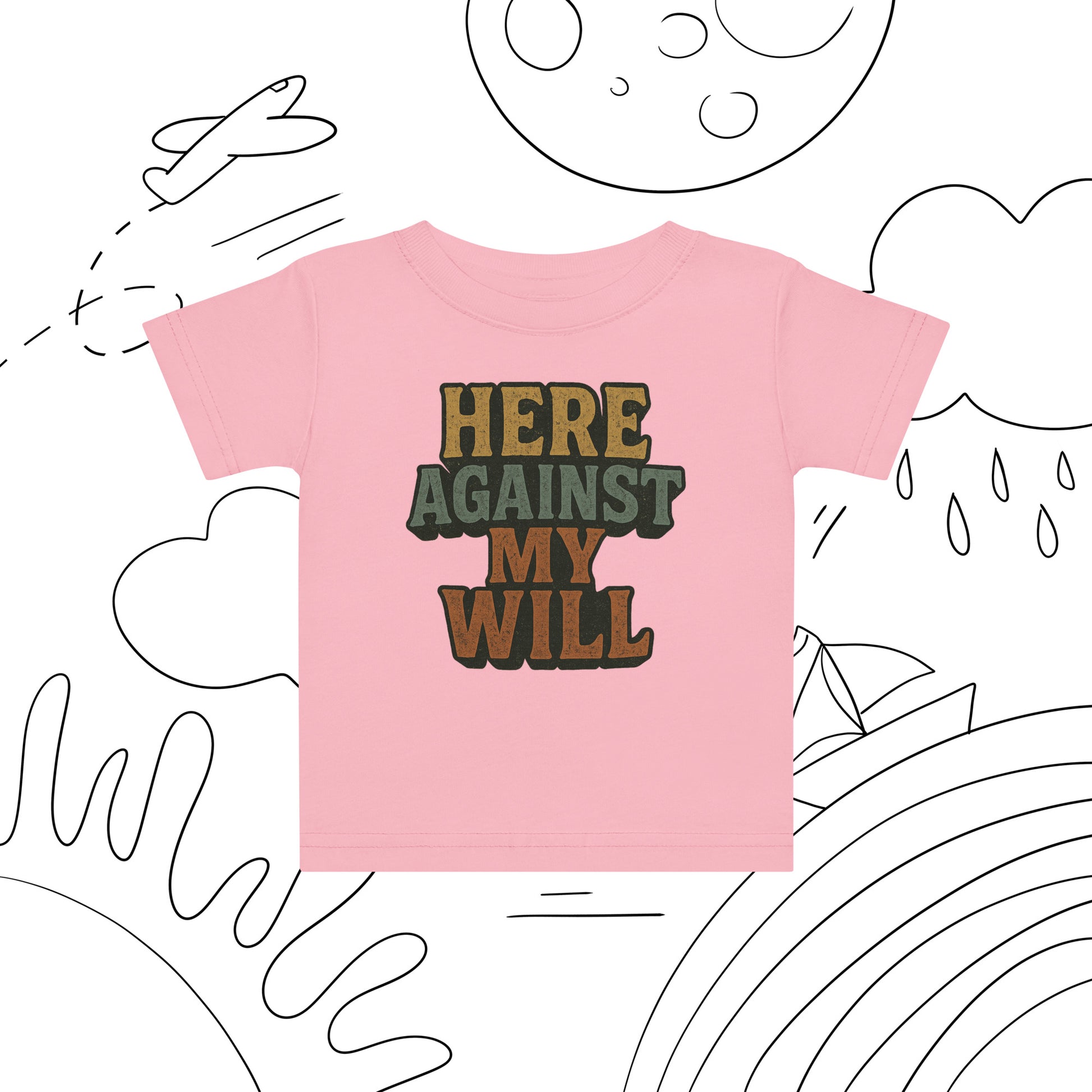 Pink t-shirt with 'HERE AGAINST MY WILL' text on a white background with black line art.