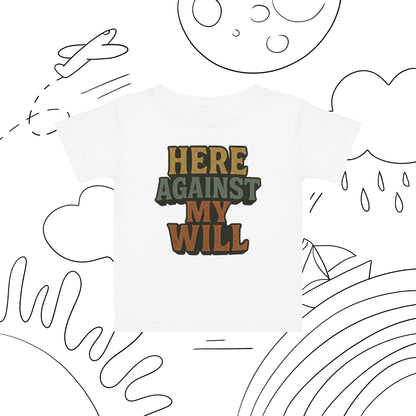 White t-shirt with 'HERE AGAINST MY WILL' text on a white background with black line art.