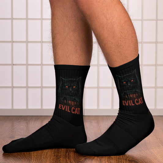 Black socks with 'Evil Cat' design worn by a person on a tiled floor.