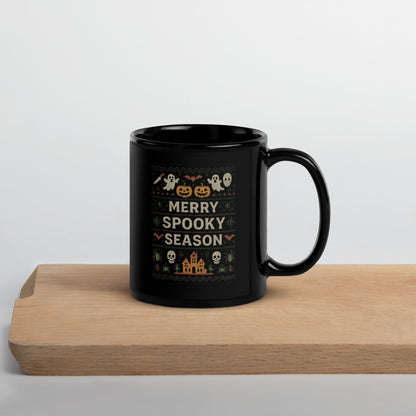 Black mug with Halloween-themed design on a wooden surface