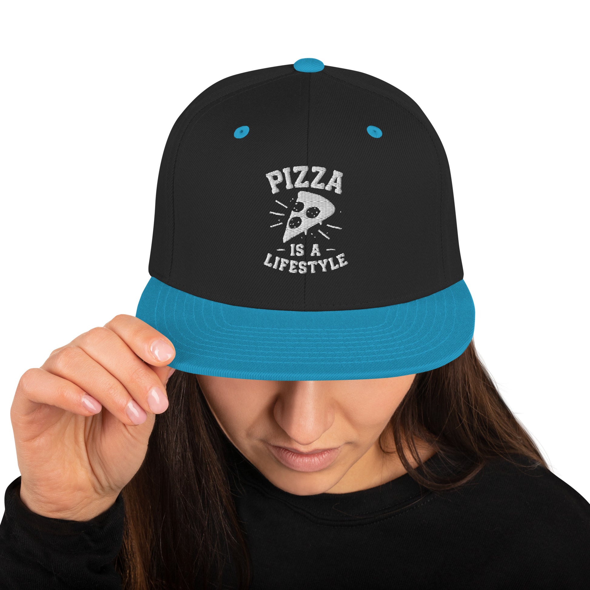 Black and blue cap with 'Pizza is a Lifestyle' text held by a person on a white background