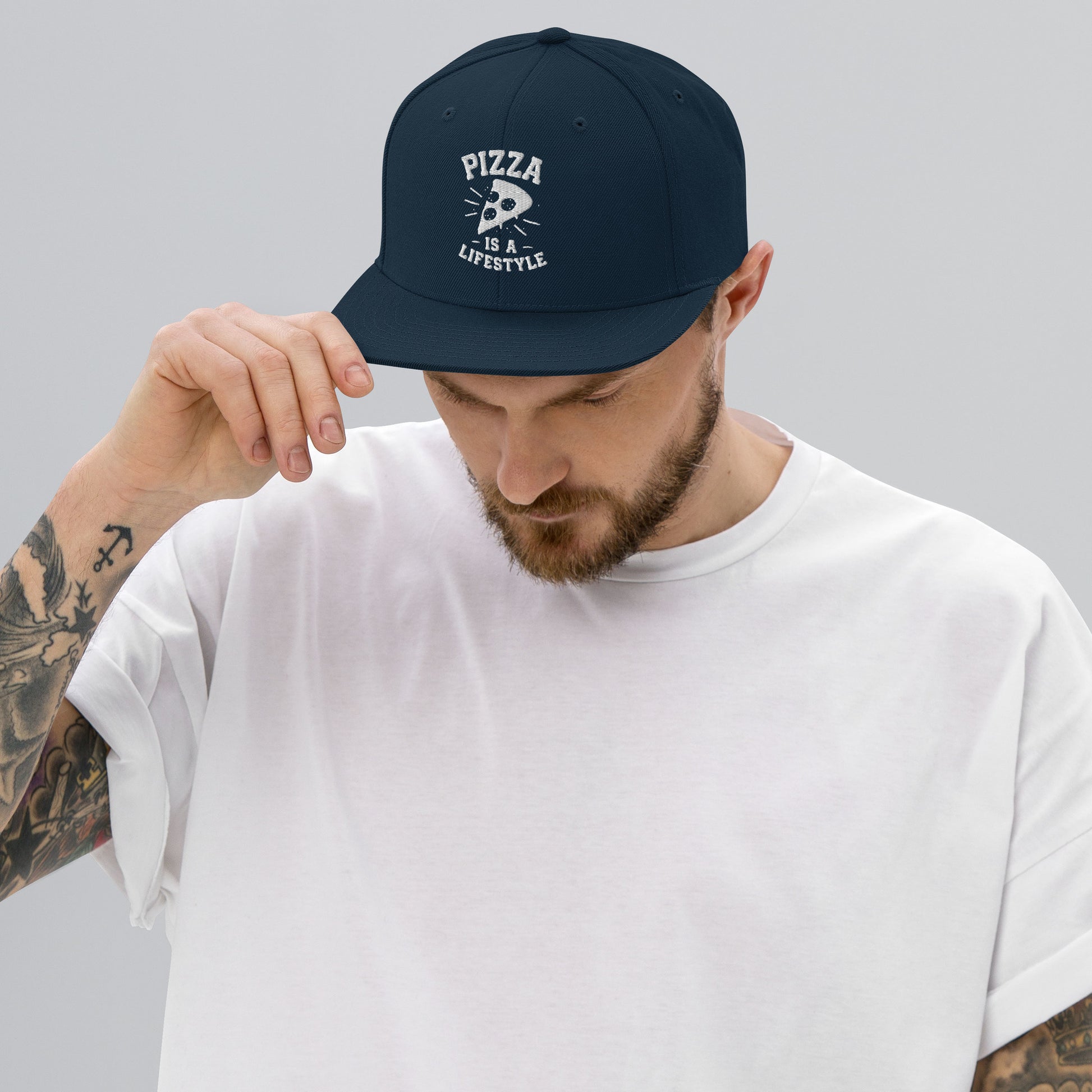 Man wearing a navy blue cap with 'Pizza is my Lifestyle' text on a gray background
