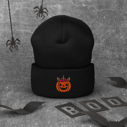 Black beanie with Halloween pumpkin design on a textured gray background with spider webs and 'BOO' letters.