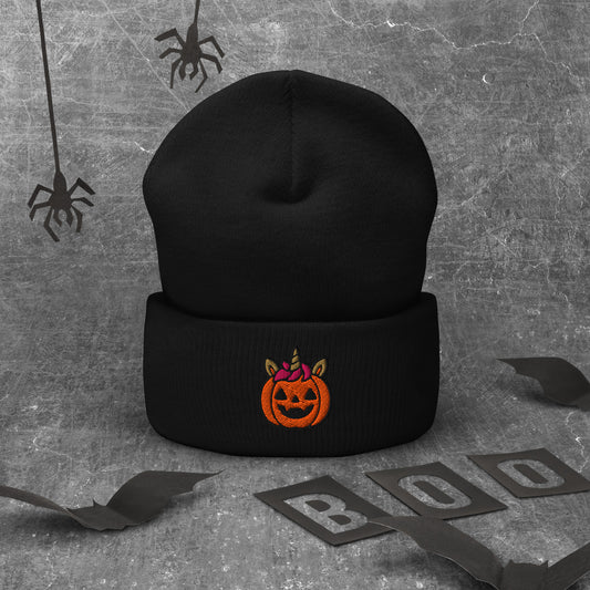 Black beanie with Halloween pumpkin design on a textured gray background with spider webs and 'BOO' letters.