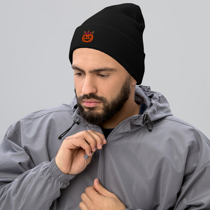 Man wearing a black beanie with a logo and a gray jacket on a light gray background