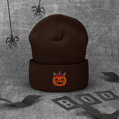 Brown beanie with Halloween pumpkin design on a textured gray background with spider webs and 'BOO' letters.
