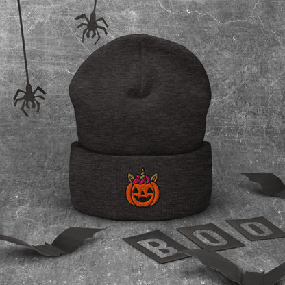 Black beanie with Halloween pumpkin design on a textured gray background with spider webs and 'BOO' letters.