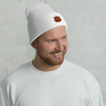 Man wearing a white beanie with a small logo against a light gray background