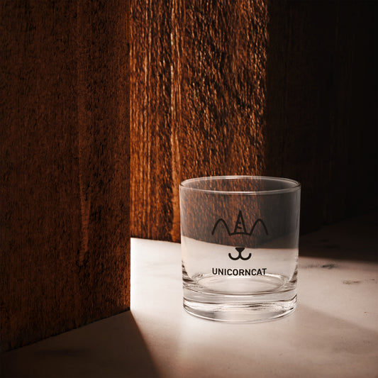 Clear glass with 'UNICORNCAT' branding on a wooden surface