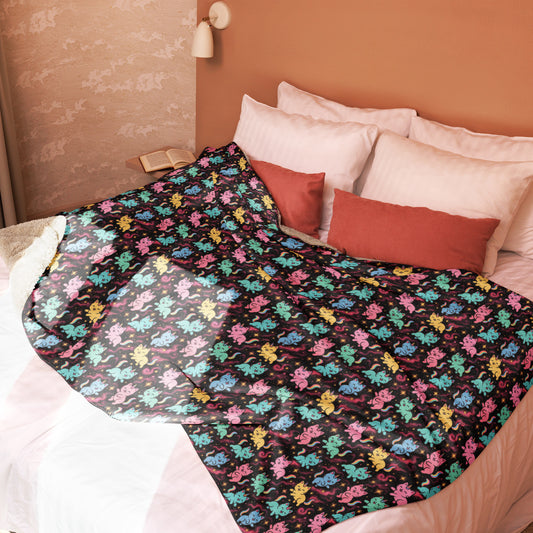 Bed with colorful butterfly patterned blanket and red pillows against a beige wall.