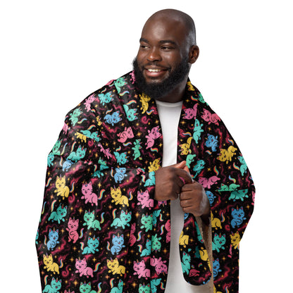 Man wearing a colorful cat patterned robe on a white background