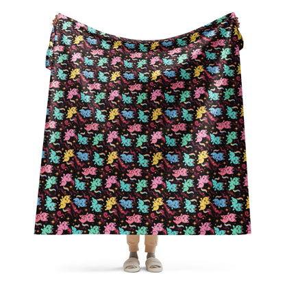 Colorful patterned blanket draped over a person on a white background