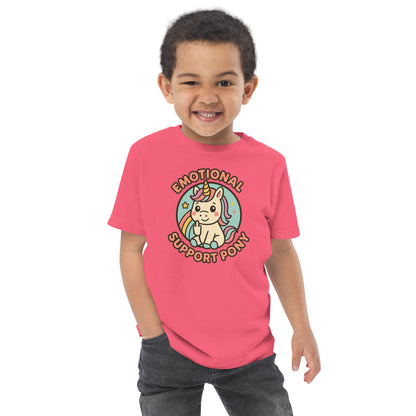 Child wearing a pink t-shirt with a unicorn graphic and text on a white background