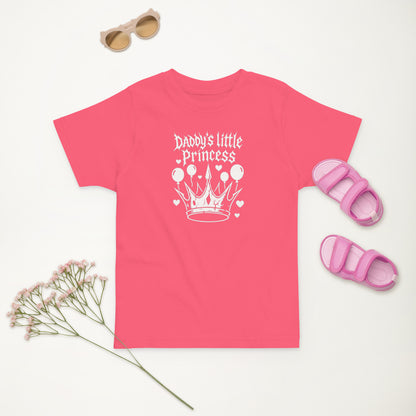 Pink t-shirt with 'Daddy's little Princess' design, sunglasses, sandals, and flowers on a light background