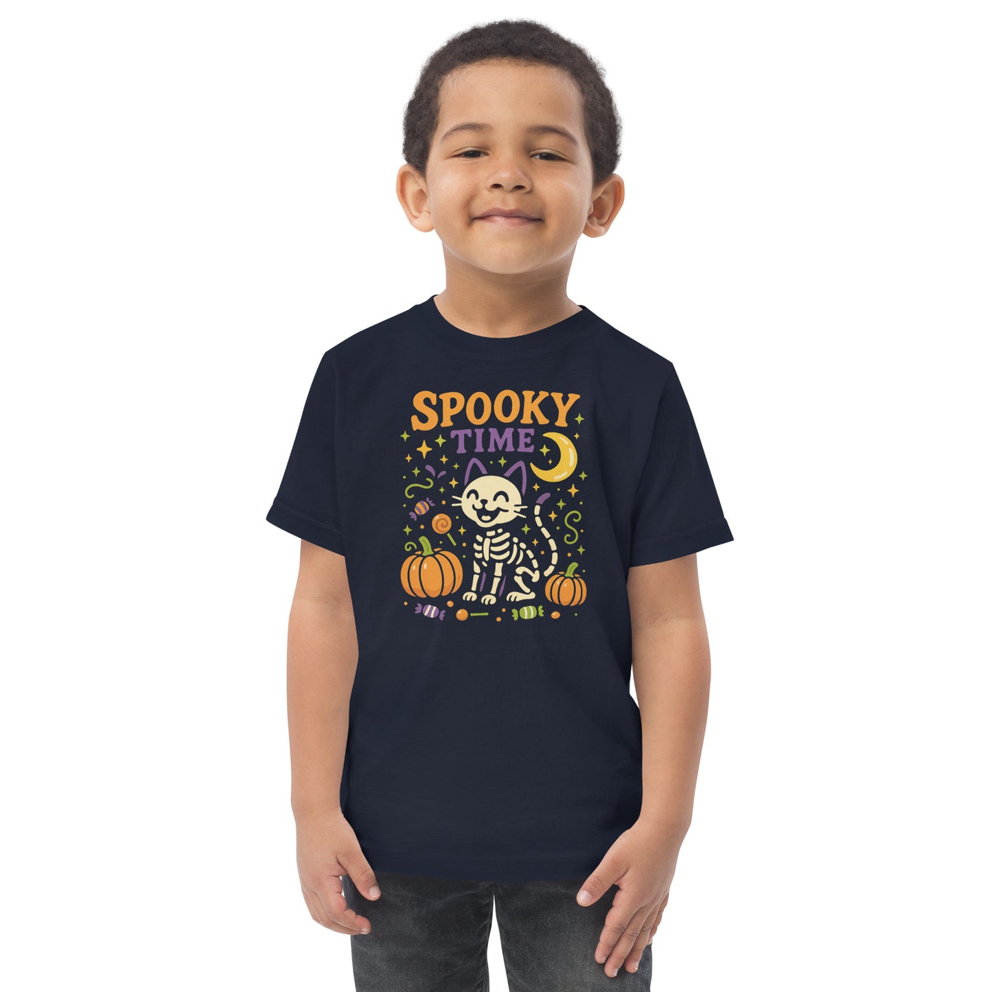 child wearing navy blueshirt with the text "Spooky Time" and a skeleton cat next to pumpkins