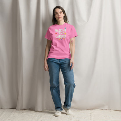 Person wearing a pink t-shirt with text and blue jeans standing against a plain background