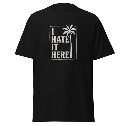 Black t-shirt with 'I Hate It Here' text and palm tree design on a white background