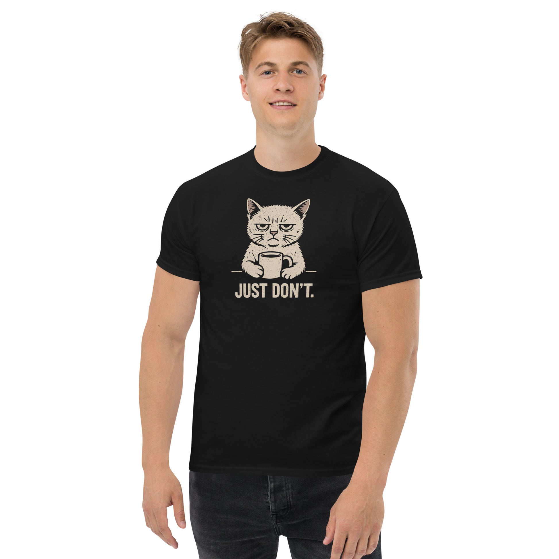 Person wearing a black t-shirt with a graphic of a cat holding a coffee cup and text 'JUST DON'T.'