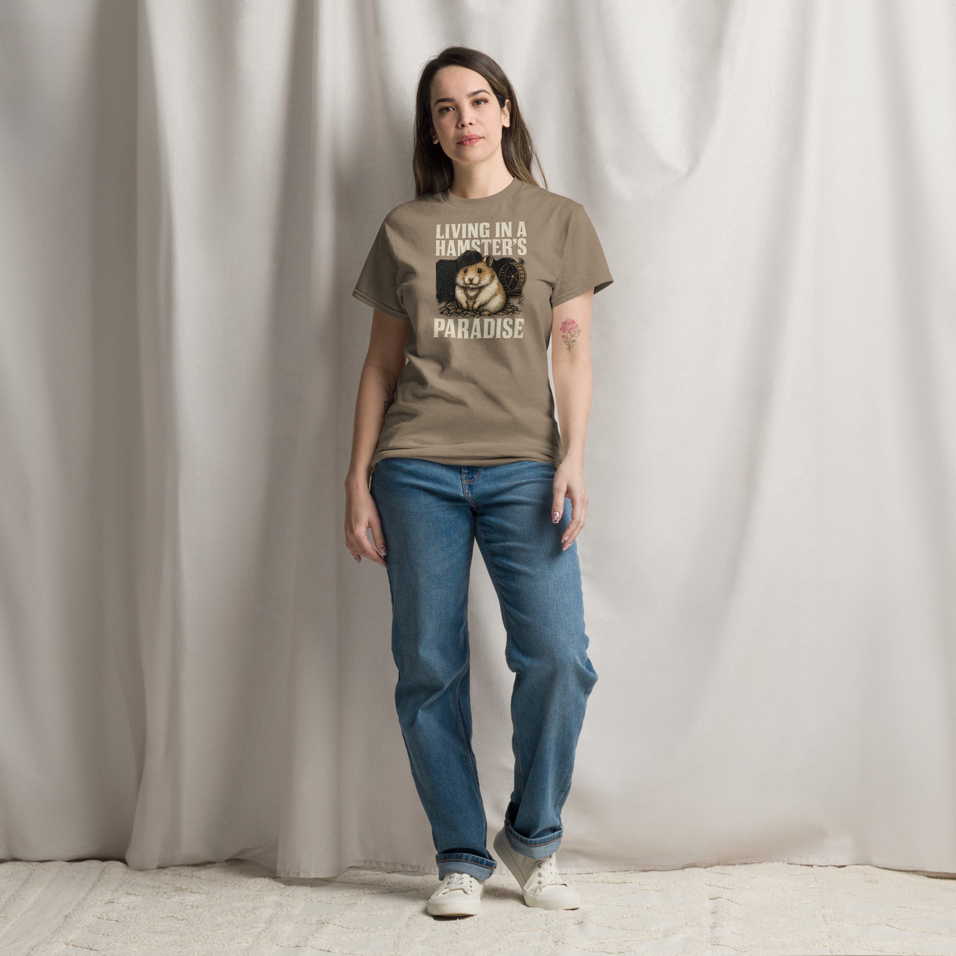 Person wearing a brown t-shirt with a graphic and text, standing against a plain background