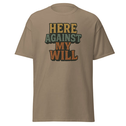 Beige t-shirt with 'HERE AGAINST MY WILL' text on a white background