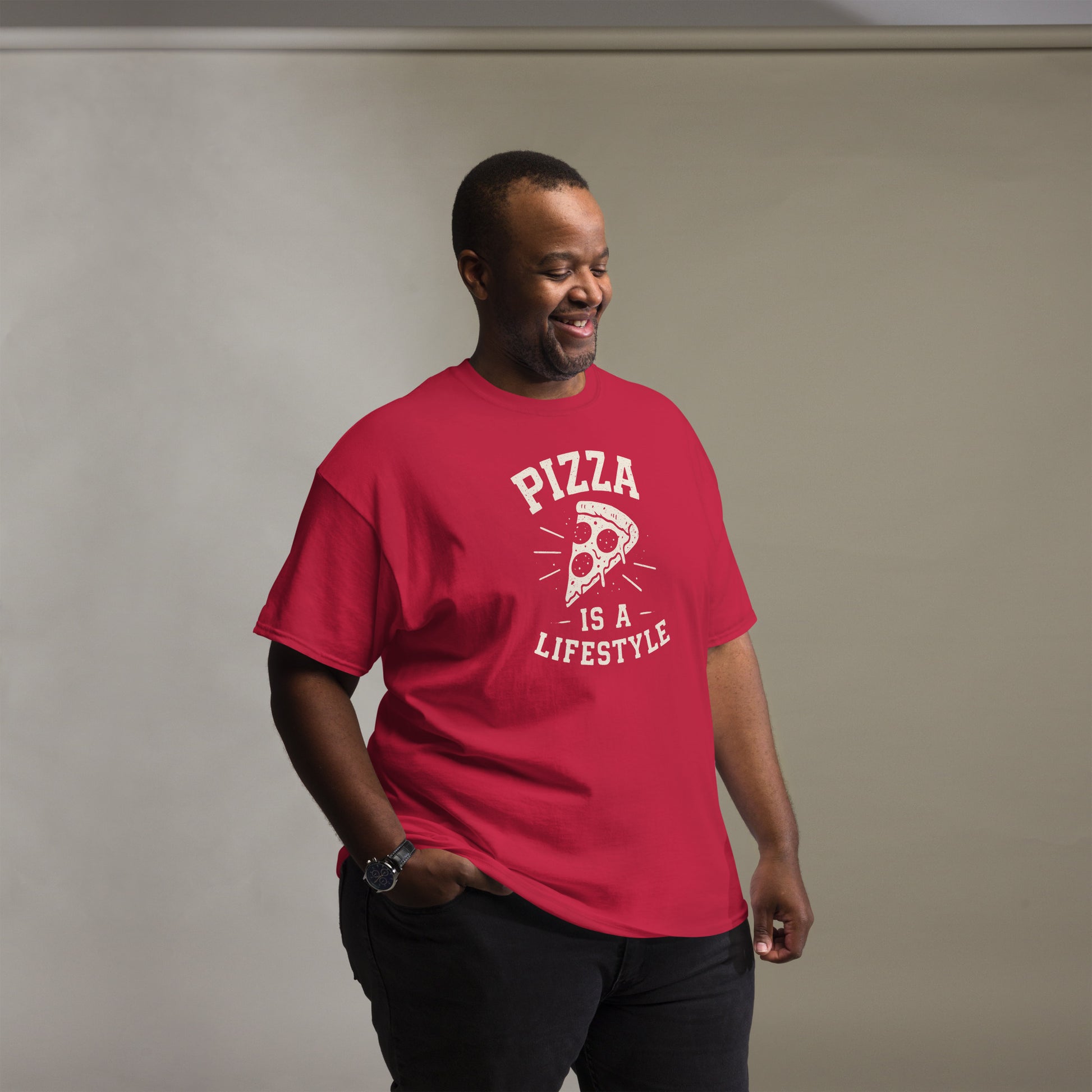 Man wearing a red t-shirt with 'Pizza is a Lifestyle' text and graphic on a plain background