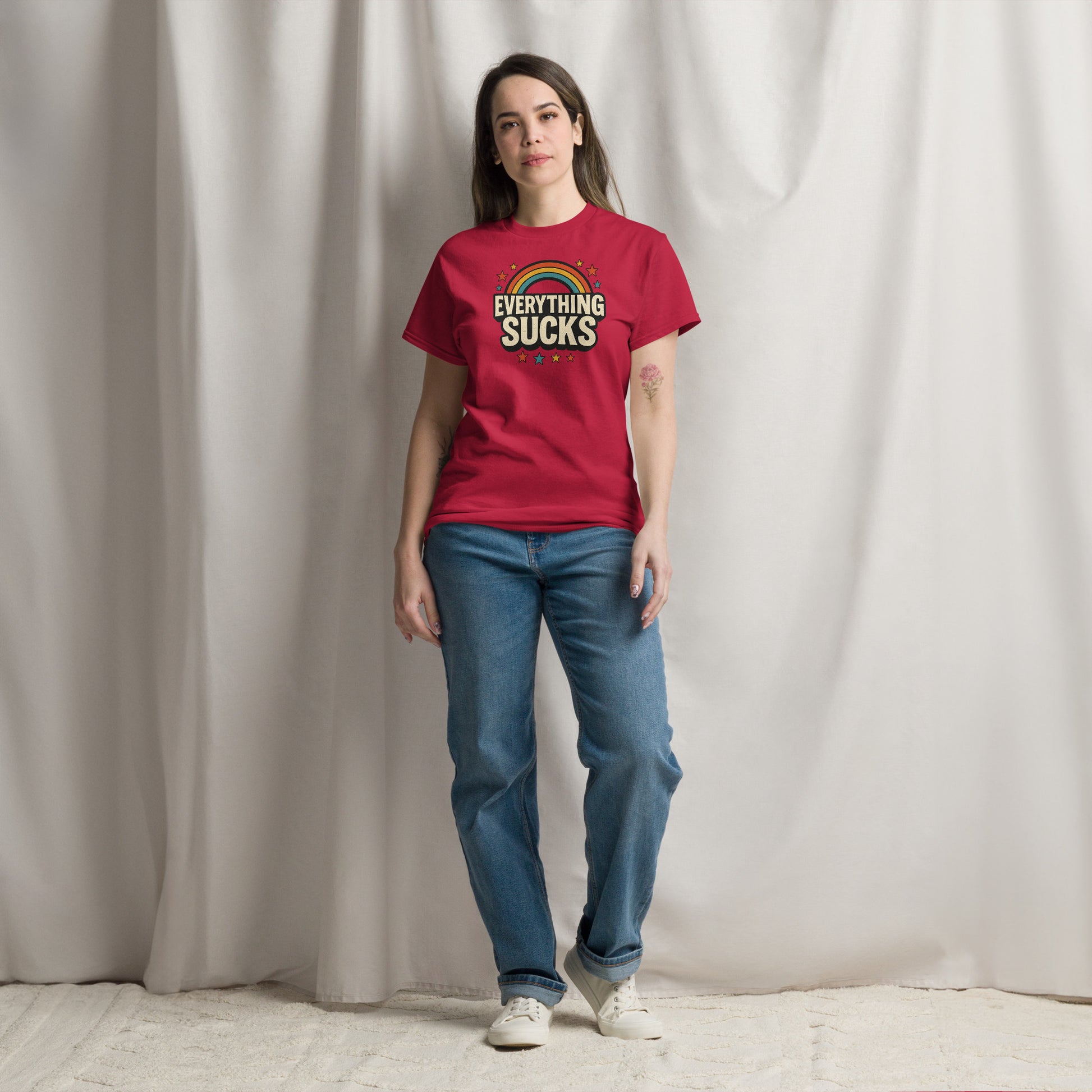 Person wearing a red t-shirt with text standing against a plain background