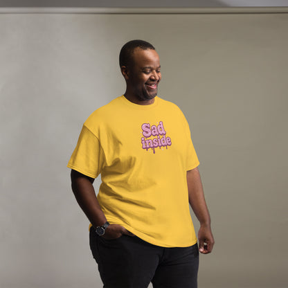 Man wearing a yellow t-shirt with 'Sad inside' text on a plain background