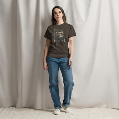 Person wearing a dark t-shirt with a graphic design of a gorilla and blue jeans against a plain background