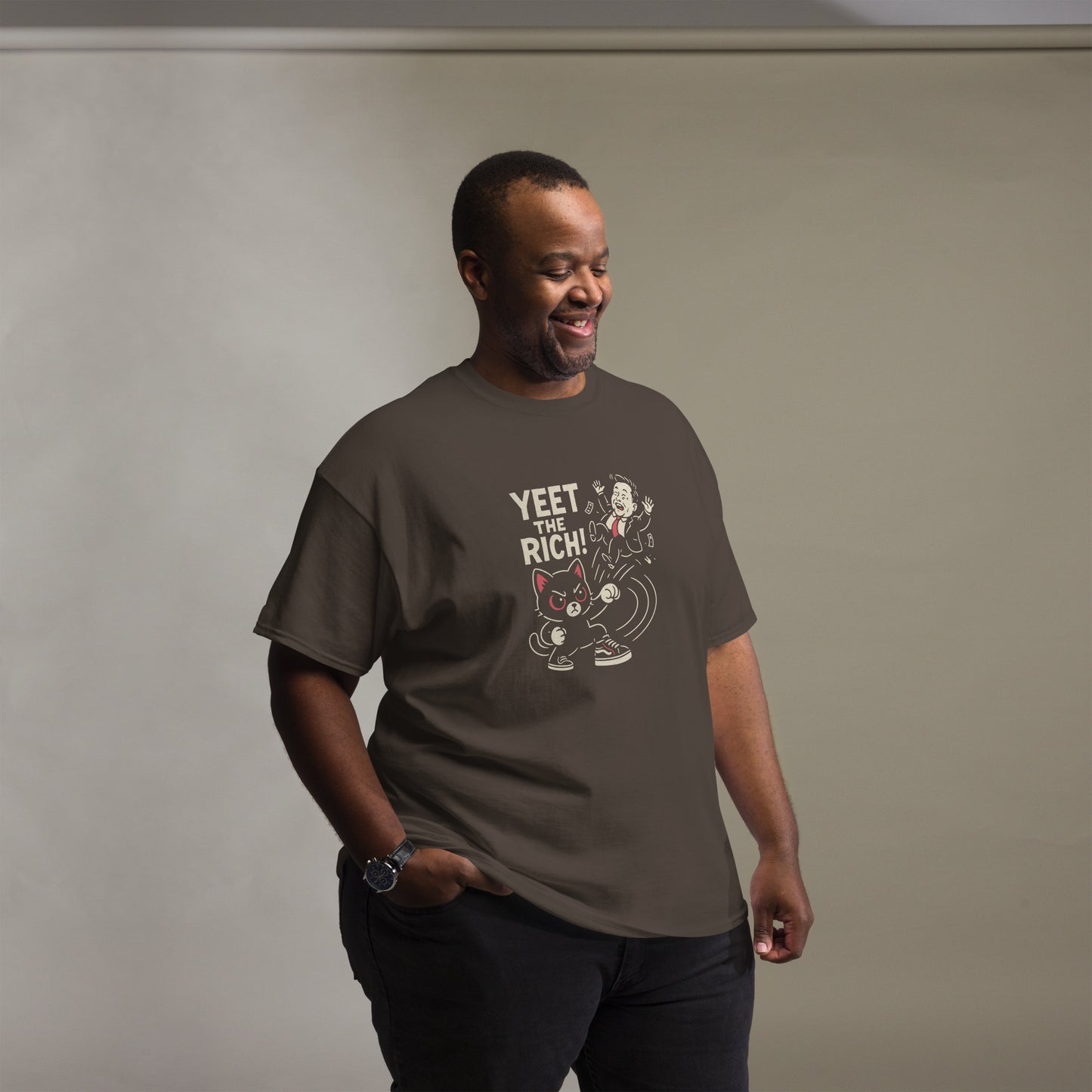 Man wearing a brown t-shirt with graphic design and text against a plain background