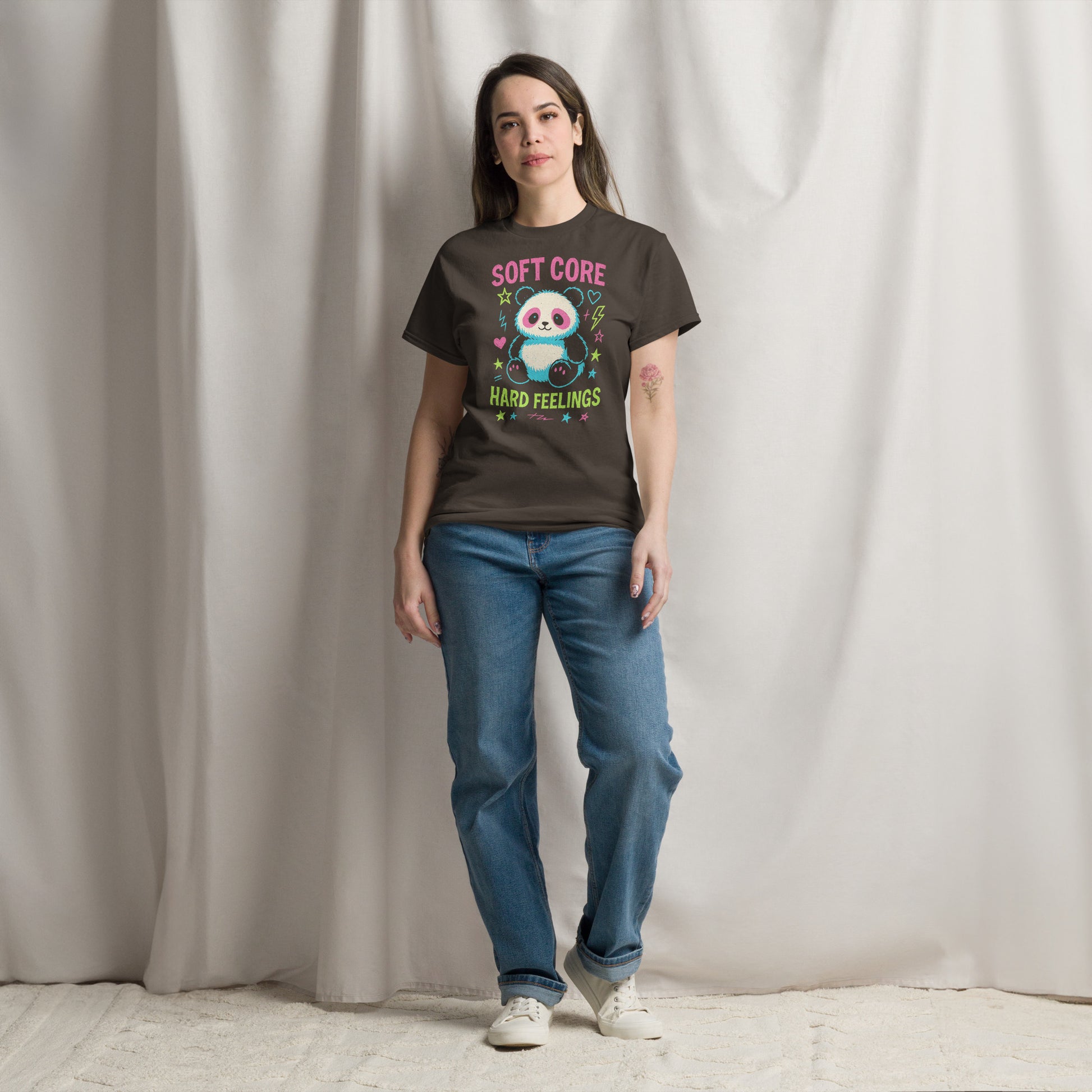 Person wearing a t-shirt with a panda graphic and text standing against a plain background