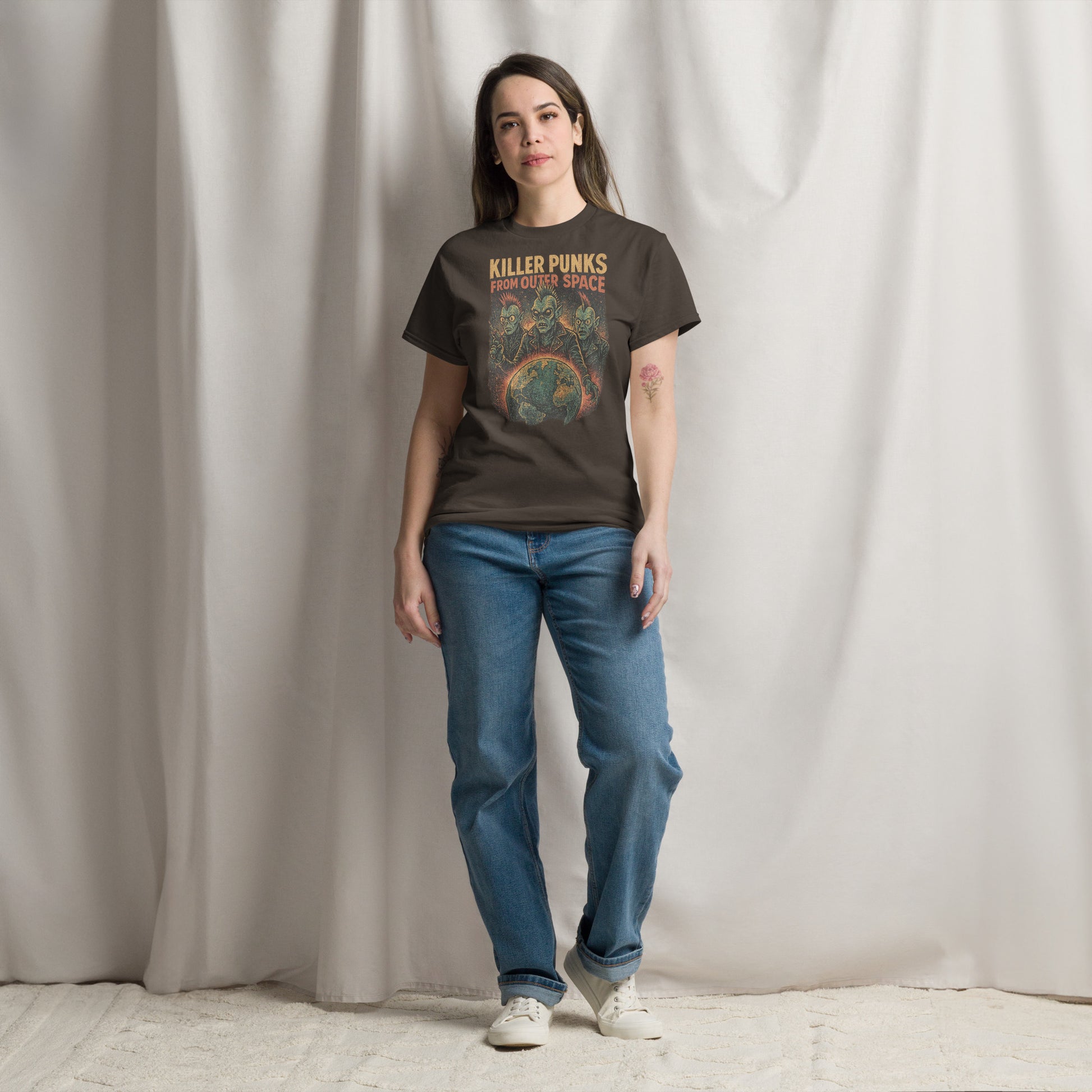 Person wearing a t-shirt with graphic design and text, standing against a plain background