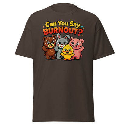 A dark brown short-sleeve t-shirt with a colorful graphic on the chest. The graphic features the text 'Can You Say BURNOUT?' in yellow and red lettering above a group of four cartoon animals: a brown bear, a gray rabbit, a yellow chick, and a pink pig.