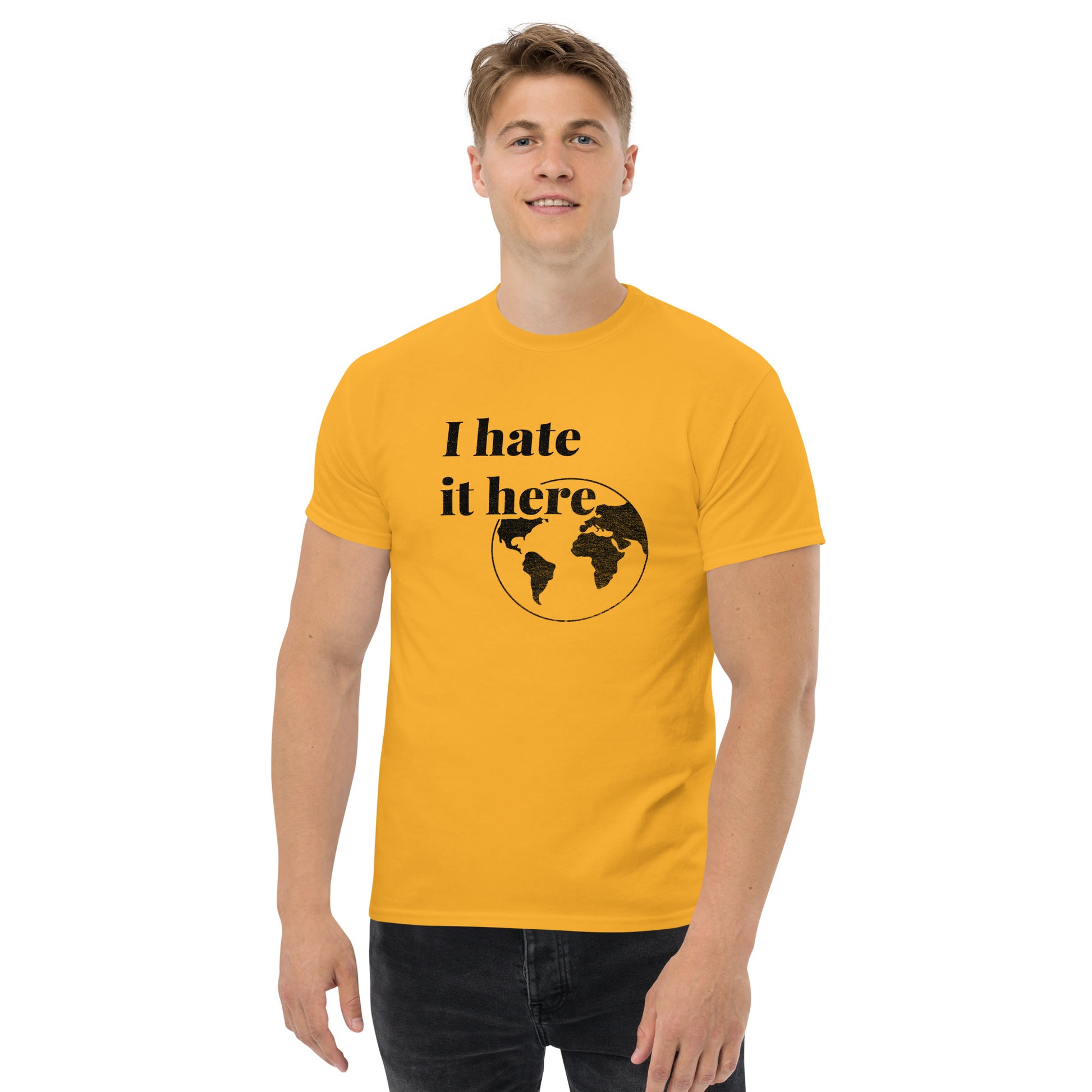 Man wearing a yellow t-shirt with 'I hate it here' design on a white background
