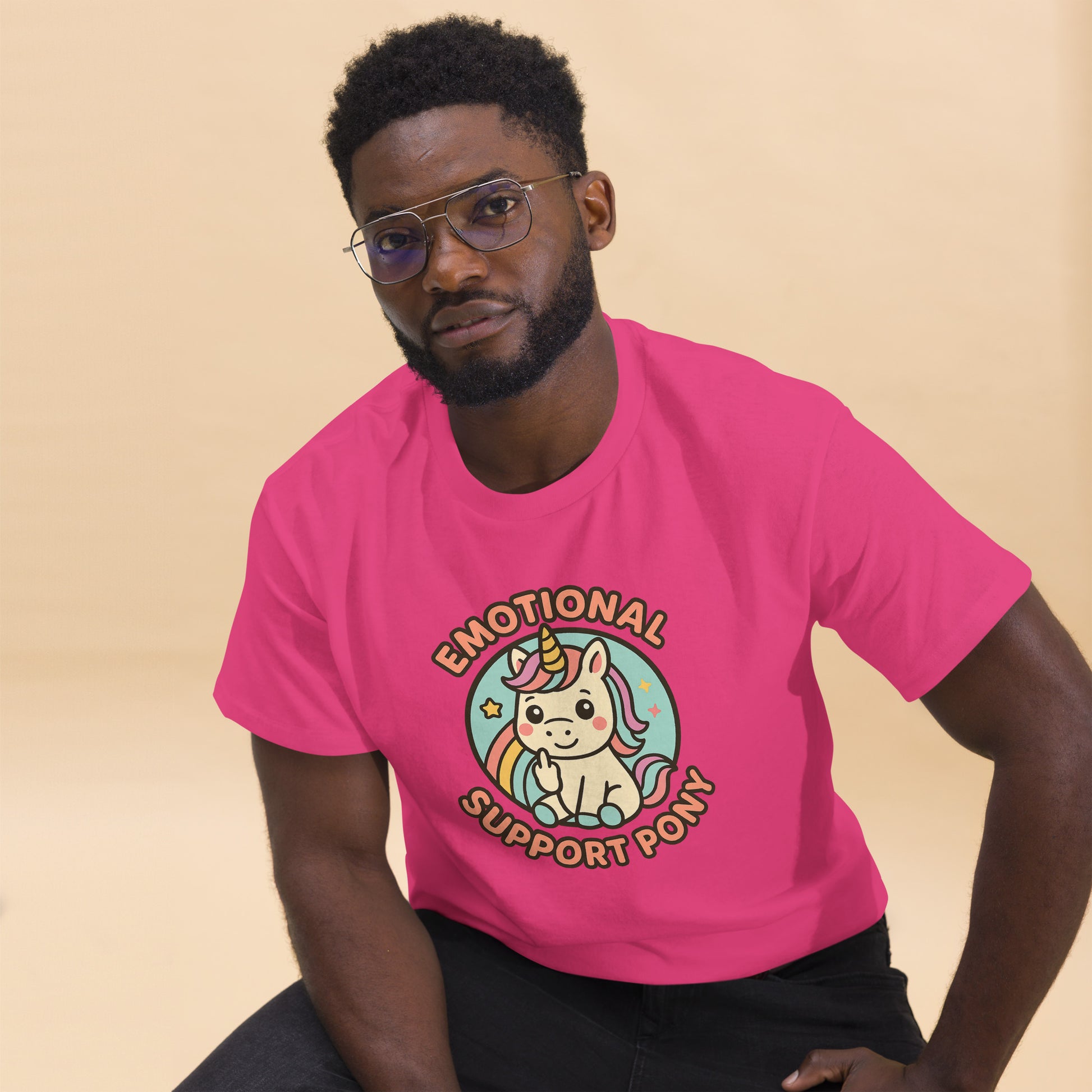 Person wearing a pink t-shirt with a unicorn graphic and text on a beige background